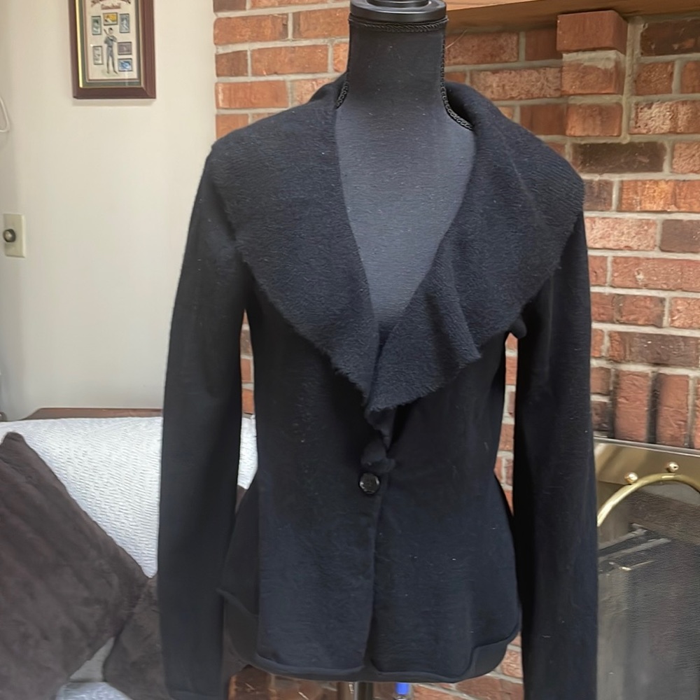 Black cashmere sweater with open ruffle collar and one black button.